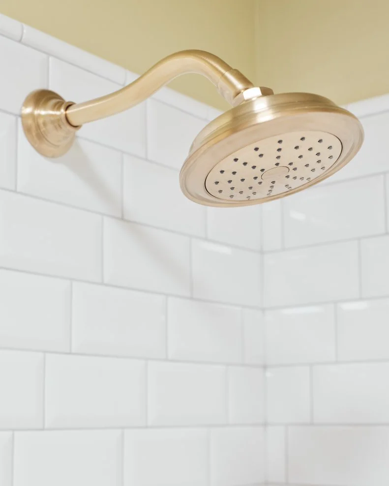 A sleek and stylish faucet control pops against the white subway tile and makes it easy to toggle from the showerhead to filling the tub with the comfort and safety of digital temperature control. The shower can also be controlled by an app, making it easy to control bath and shower settings from a smartphone.